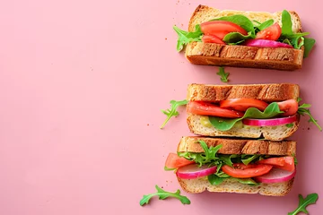 Foto op Plexiglas anti-reflex Tomato and arugula sandwich on toasted bread. Studio food photography on a pink background. Healthy lunch and vegetarian food concept. Flat lay composition with copy space © Alexey