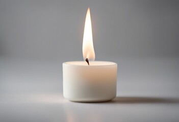 White candle burning on a white background