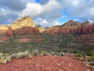 A woman walking with her daughter in the trails of Sedona, Arizona on a beautiful sunny winter day,...