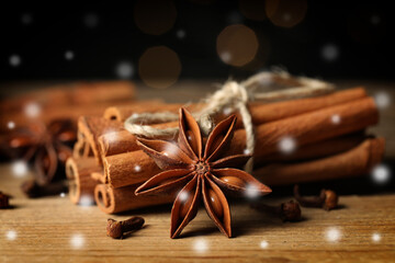 Different spices on wooden table, closeup. Cinnamon, anise, cloves