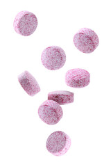 Obraz na płótnie Canvas Vitamin. Pink tablets falling on white background
