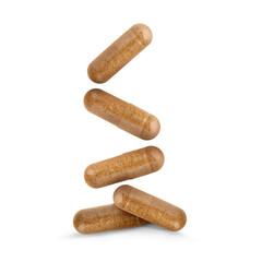 Vitamin. Many capsules falling on white background