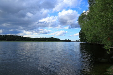 Cloudy summer landscape at a lake.  One day in june 2023. Mälaren, Stockholm, Sweden.