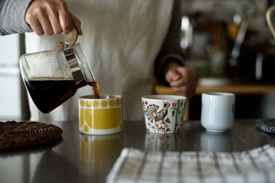 ドリップし終わったコーヒーをカップに入れているところ