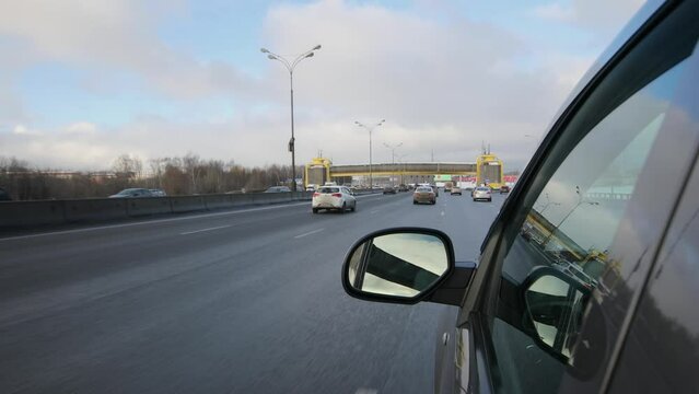  Car rides by highway with traffic at winter day