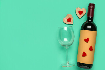 Composition with bottle of wine and glass for Valentine's day on turquoise background