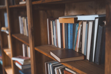 Single Book Resting On Bookshelf In Library, Highlighting The Intricate Details Of Its Cover And Spine. Literature And Education, Showcasing Organized Arrangement Of Books Within Library. Close-Up