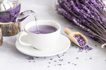 Cup of lavender tea with dried lavender flowers on rustic table, herbal relaxing tea. Lavendula oleum
