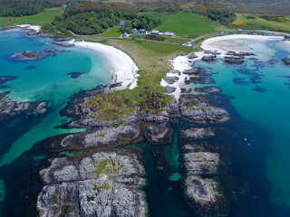 Blue , transparent and clear water Scotland uk near Arisaig Scottish Highlands beautiful white sandy beach Scottish tourist destination located south of Mallaig
