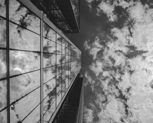 Dramatic Monochrome Cityscape: Skyscraper Reflections Amidst Moody Clouds