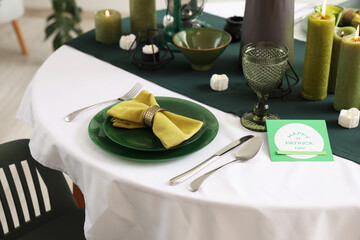 Festive table serving with greeting card for St. Patrick's Day celebration, closeup