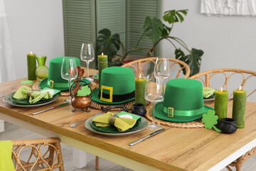 Festive table serving with leprechaun's hats, horseshoe and clovers. St. Patrick's Day celebration