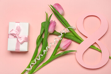 Obraz na płótnie Canvas Figure 8 made of paper with beautiful tulips and gift box on pink background. International Women's Day