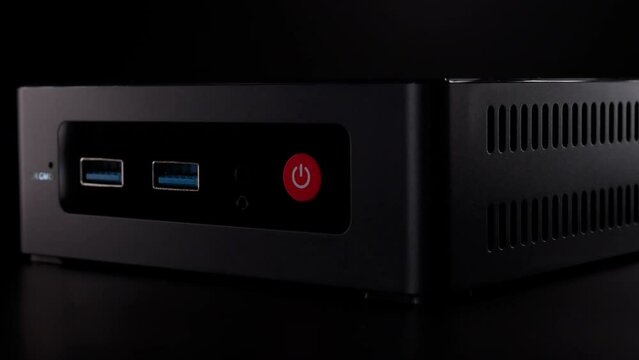 Mini PC. Great computer to use as a HTPC to play games and watch TV shows and movies. Close-up of the front, where USB ports can be seen. High quality 4k footage