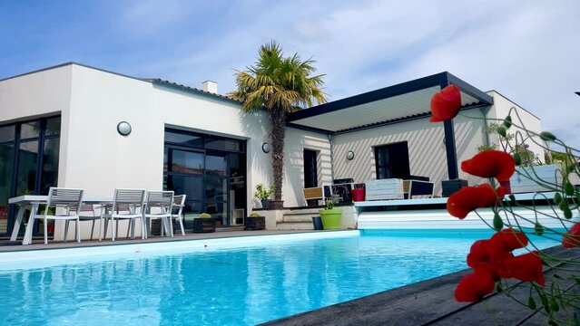 Trendy outdoor patio pergola shade structure, awning and patio roof, garden lounge, chairs, metal grill surrounded by landscaping