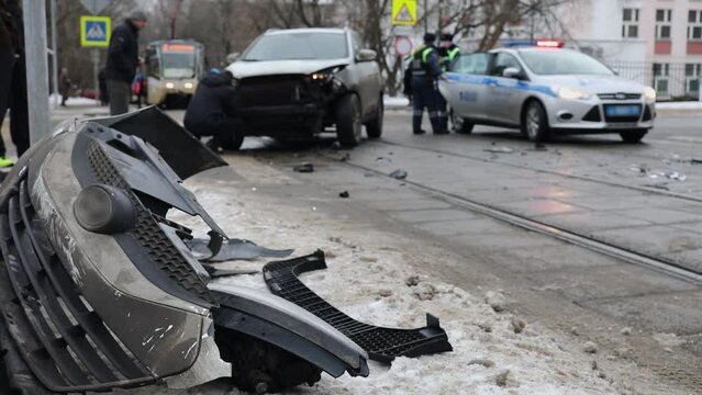 Man throw car debris on road side after accident on city street