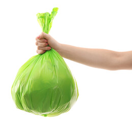 Woman holding plastic bag full of garbage on white background, closeup