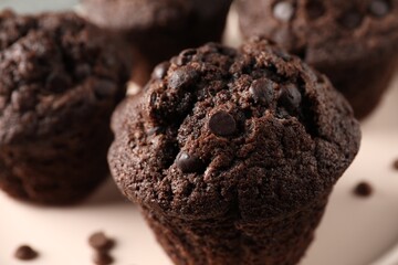 Delicious fresh chocolate muffins on table, closeup
