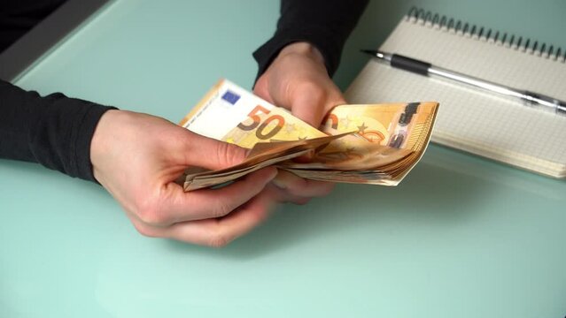 4K close up footage of female hands counting 50 euro  banknotes.