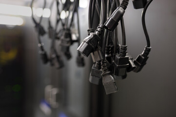 Computer power cord cables (IEC 60320 C14) hanging in the server room.