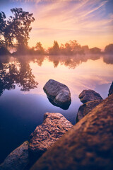 Rocky lake shore during sunrise. High quality photo - 730452445