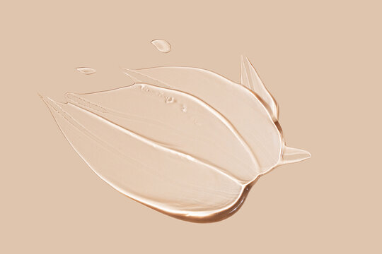 Smooth beige makeup foundation smear on neutral background