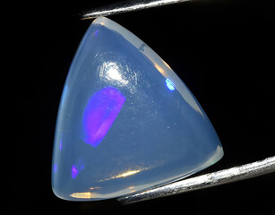 natural rainbow multi color opal gem on the background