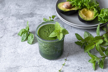 Blended green smoothie with ingredients. Healthy smoothie