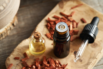 Two bottles of essential oil with red sandalwood