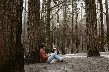 Digital nomad and remote working concept lifestyle people with man sitting ou the ground inside a...
