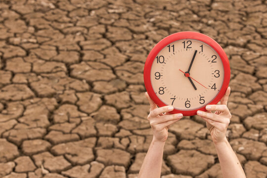 person holding watch, dry river countdown, climate change crisis, drought, drought