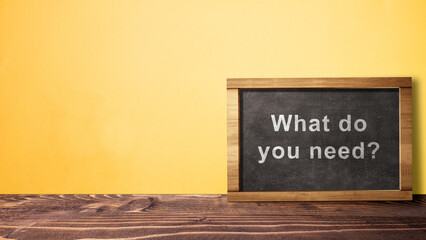Text of 'What do you need?' on the chalkboard. Symbol of The customer's needs