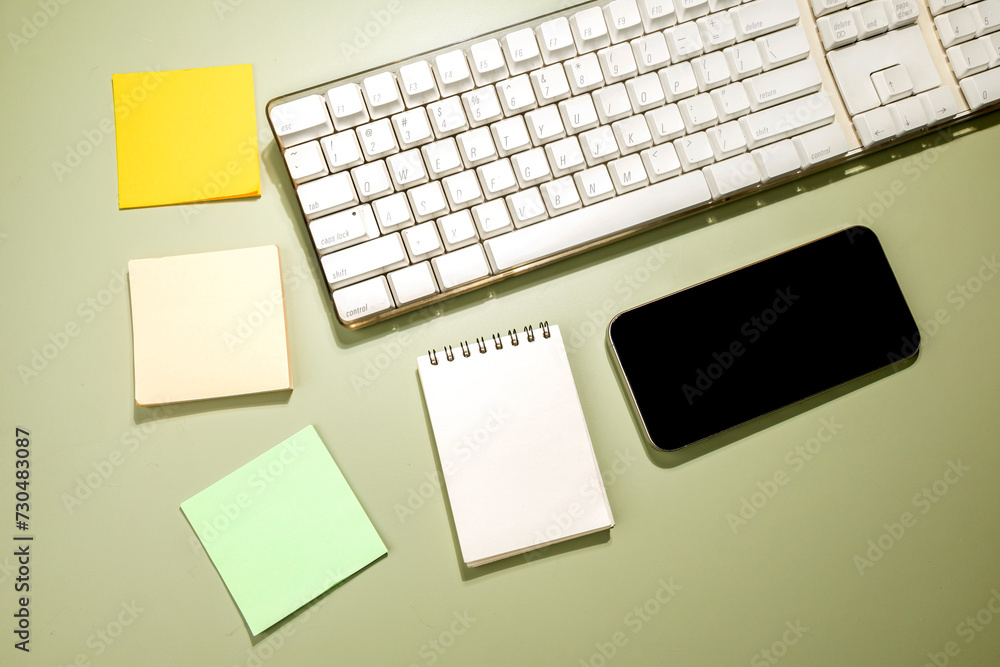 Aufkleber closeup view of mobile phone with blank screen and an empty notebook and note paper
