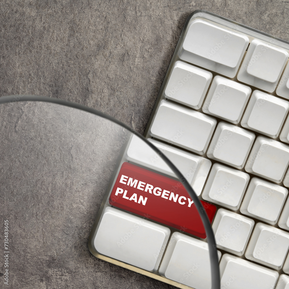 Poster the magnifying glass focuses on the keyboard button with 'emergency plan' text