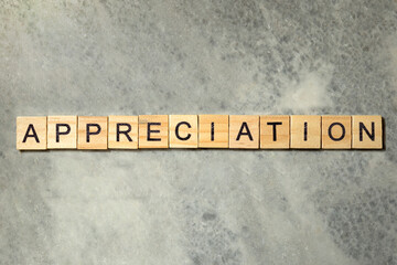 The row of wooden cubes with 'Appreciation' text