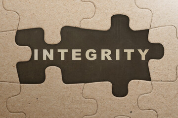 Piece of missing jigsaw puzzle with integrity text
