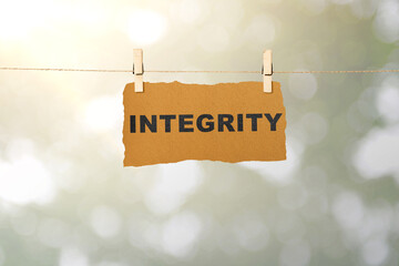 Ripped paper hanging on the rope with integrity text