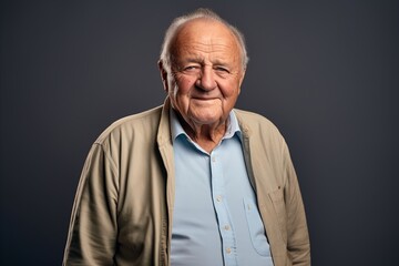 Portrait of an old man in a shirt on a dark background