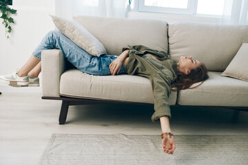 Sad, Worried Woman Sitting on Couch, Expressing Depression and Anxiety at Home