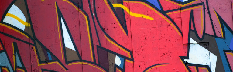Colorful background of graffiti painting artwork with bright aerosol outlines on wall. Old school street art piece made with aerosol spray paint cans. Contemporary youth culture backdrop