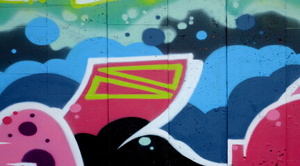 Colorful background of graffiti painting artwork with bright aerosol outlines on wall. Old school street art piece made with aerosol spray paint cans. Contemporary youth culture backdrop