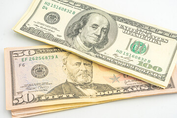 Close up of different dollar bills. Isolated on a white background. 100 and 50 dollar bundles up...