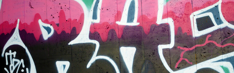 Colorful background of graffiti painting artwork with bright aerosol outlines on wall. Old school street art piece made with aerosol spray paint cans. Contemporary youth culture backdrop