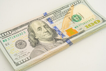 Dollars pack isolated on white background. Several 100 dollar bills are stacked up