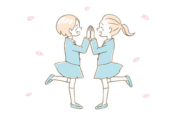 喜び合う学生の女の子たちと桜の花びら