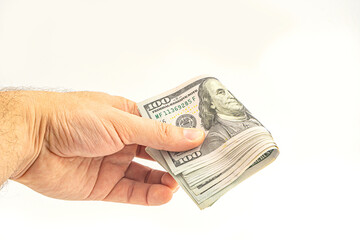 Hand holding money isolated on white background. One hundred Dollars bill on man hand to paying and...