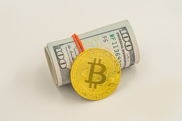American US dollar bills in rolls with silver Bitcoin coin. bitcoin BTC coin and roll of dollar...