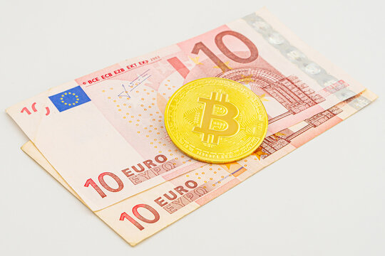 photo of golden bitcoins new virtual currency with traditional dollars and euro as a background. bitcoin to euro, crypto concept. Bitcoin in Europe