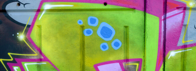 Colorful background of graffiti painting artwork with bright aerosol outlines on wall. Old school...