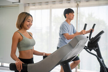 Fototapeta na wymiar Sporty people exercising in fitness gym